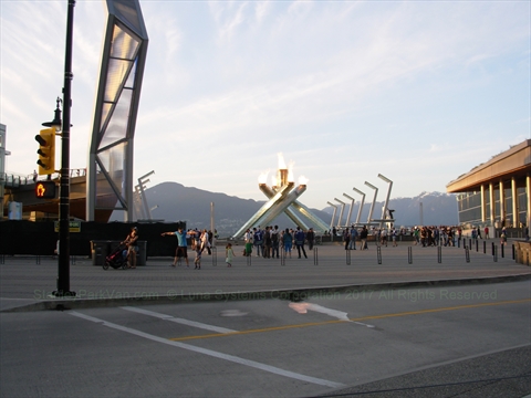 Pedestrians exploring Jack Poole Plaza outside the convention center