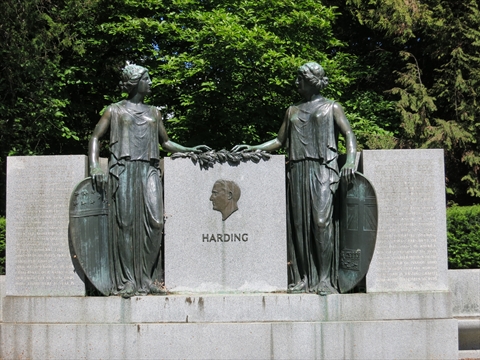 The stone architecture columns of the historic Harding Memorial site inside the park woods