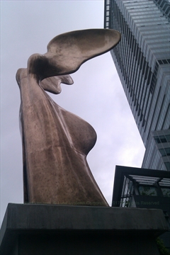 Bronze Nike Winged Victory sculpture overlooking the ocean harbor