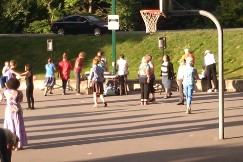 Dancers gathered for open-air cultural folk dancing at sunset in Stanley Park
