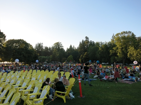 Reserved Adirondack chairs arranged in the front VIP rows at the outdoor movie