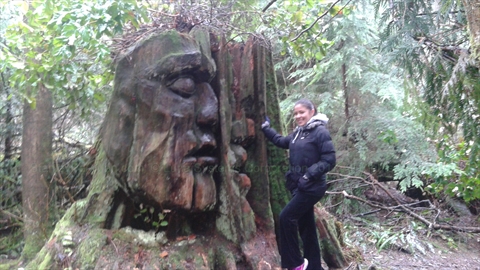 Two Spirits art work surrounded by natural forest backdrop