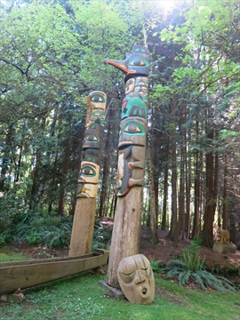 Two historic totem poles situated deep along the inner railway forest loops