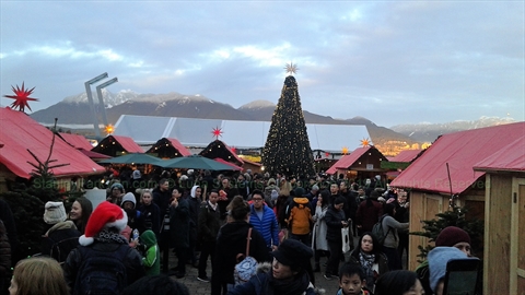 Outdoor dining tent area lit up at Jack Poole Plaza