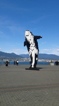 Digital Orca with the Olympic Cauldron in the background at Jack Poole Plaza