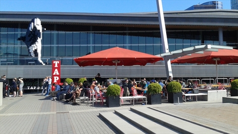 Pedestrians relaxing near the water features of Jack Poole Plaza