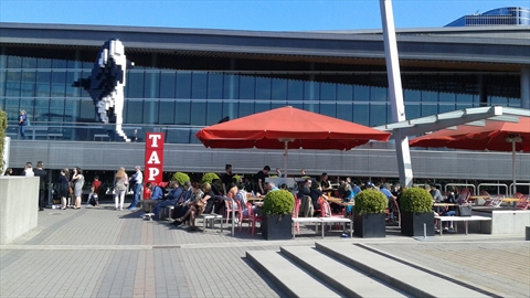 Large two-tiered dining patio of Tap and Barrel brewpub on the plaza