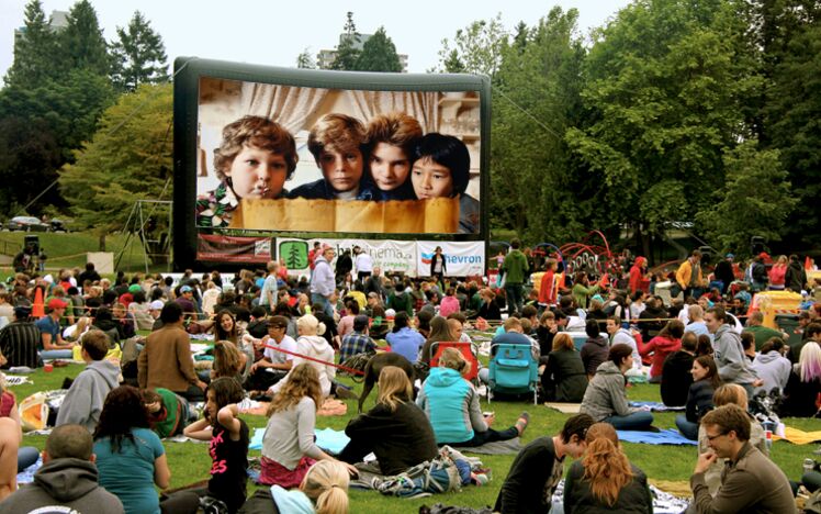Crowds gathering for a Free Weekly Outdoor Movie in Stanley Park, Vancouver, BC, Canada