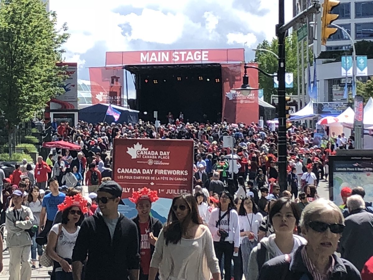 Massive public crowds celebrating Canada Day at the waterfront plaza