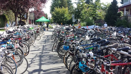 Bicyclists racing in the Vancouver International Triathlon across Stanley Park paths