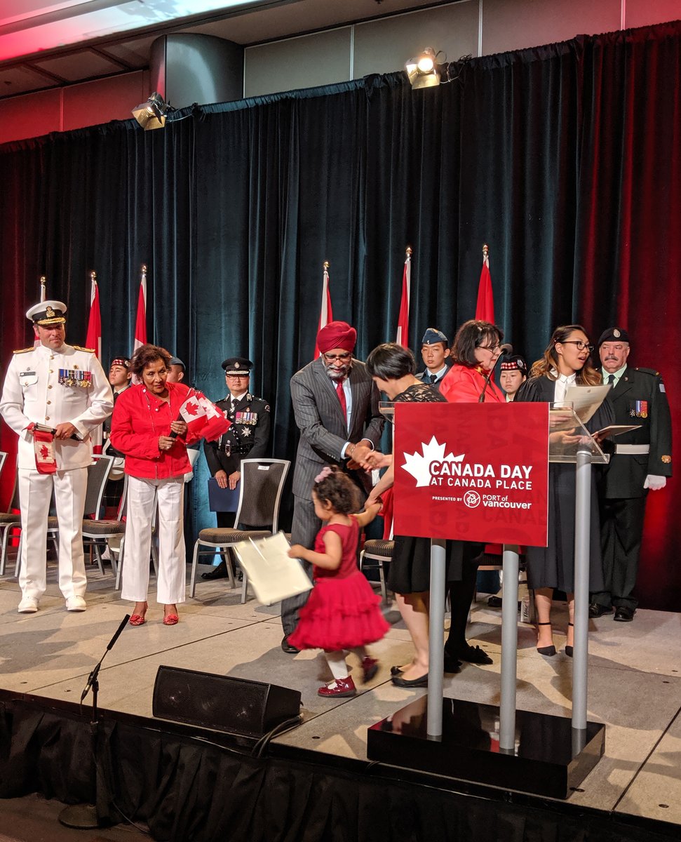 New citizens taking the formal oath of citizenship inside Canada Place