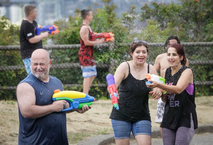 Large crowds using water guns at the unsanctioned Vancouver Water Fight event
